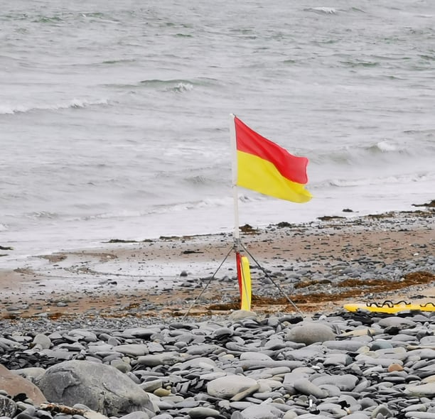 Lifeguard red and yellow patrol flag on the beach