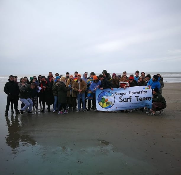 Aberystwyth and Bangor University surf clubs posing for a picture