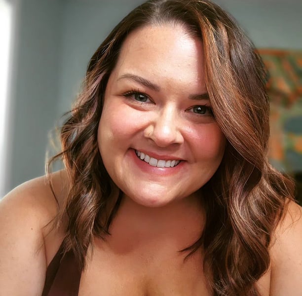 Caucasian woman smiling at camera; brown hair
