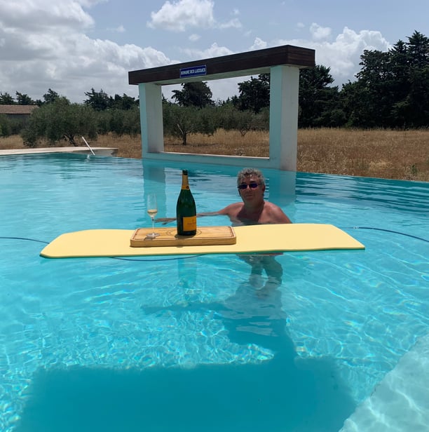 Guest enjoying the infinity swimming pool at Domaine Des Lucques