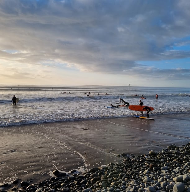 A busy surf lesson at Ynyslas in late evening autumn sunshine