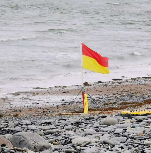 Lifeguard red and yellow patrol flag on the beach