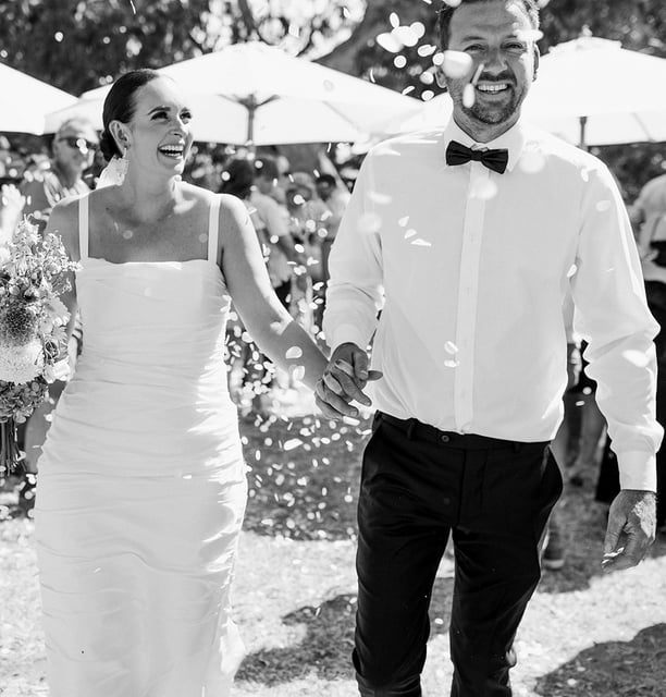 Newlyweds walk down the aisle at a Noosa beach wedding ceremony