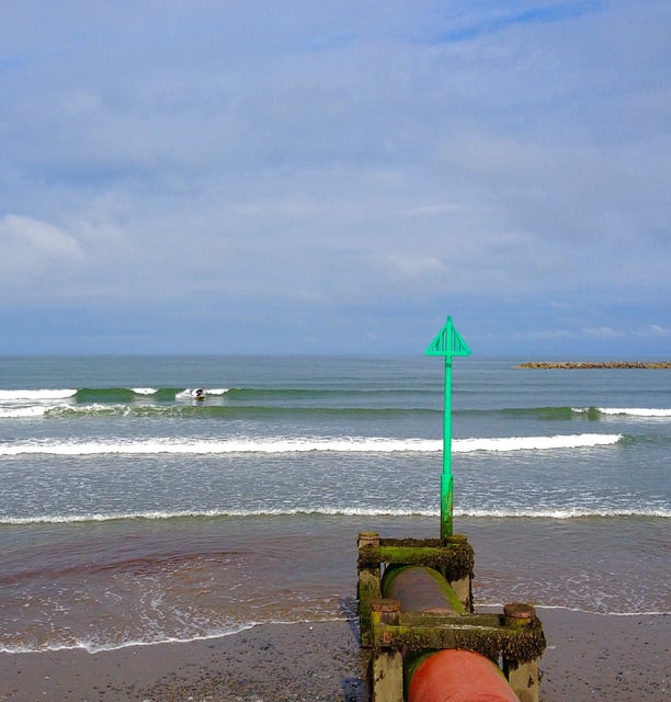 Borth looking along the stream pipe with the green pole and triangle