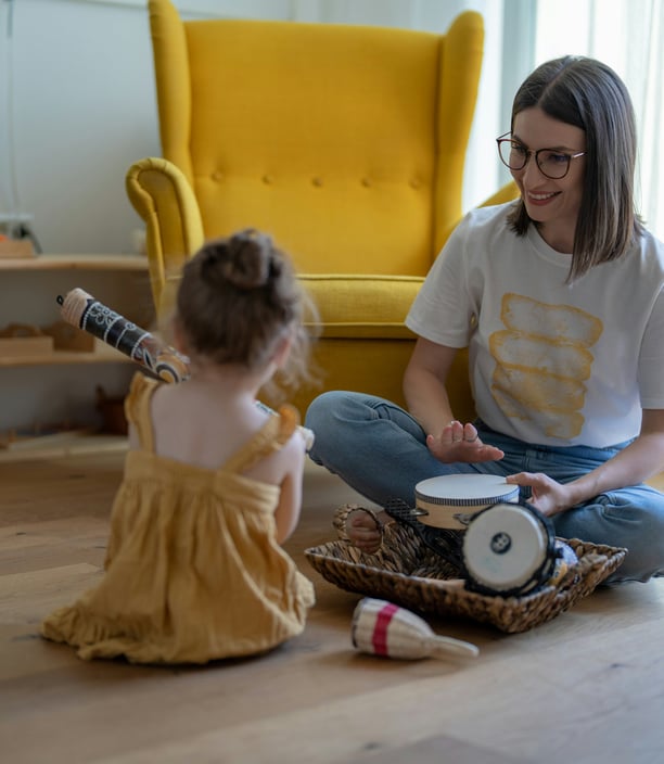 a person and a child sitting on the floor