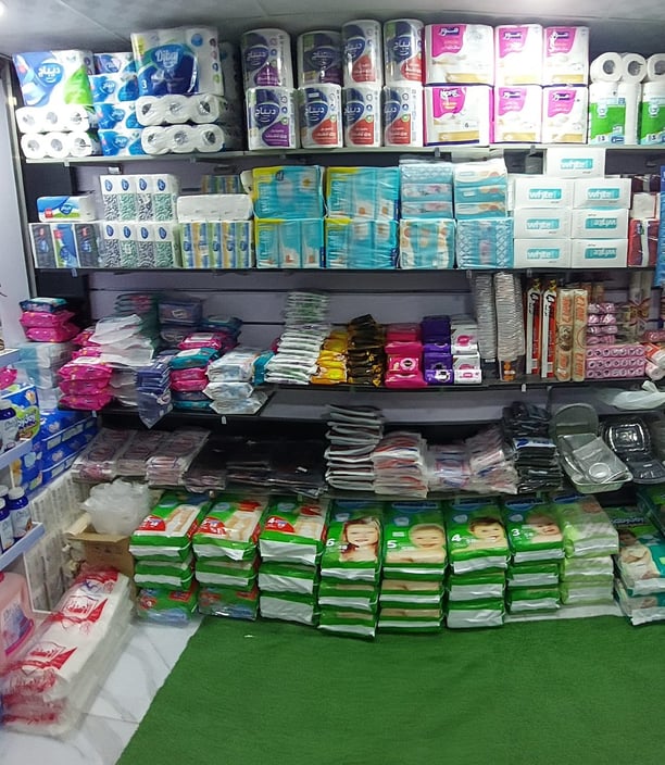 a store with a lot of toilet paper rolls