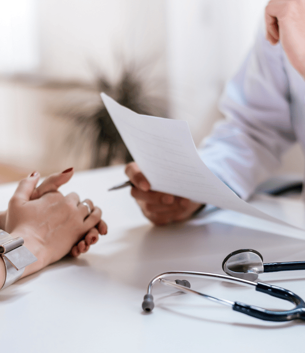 a doctor and a woman sitting at a desk