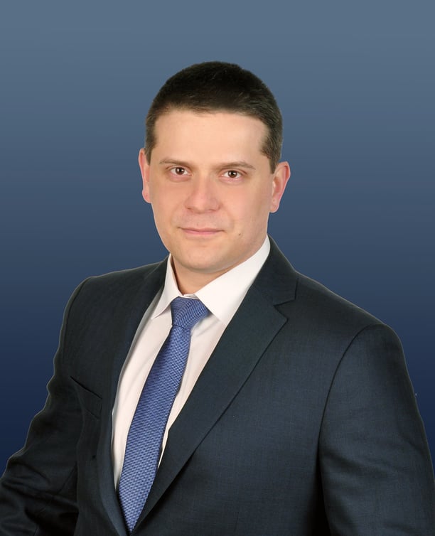 a man in a suit and tie with a blue tie