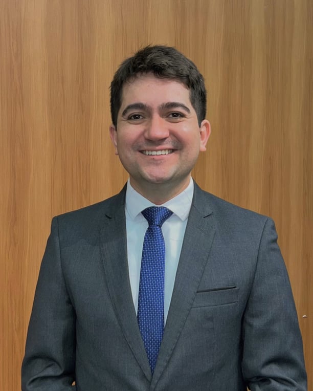 a man in a suit and tie smiling