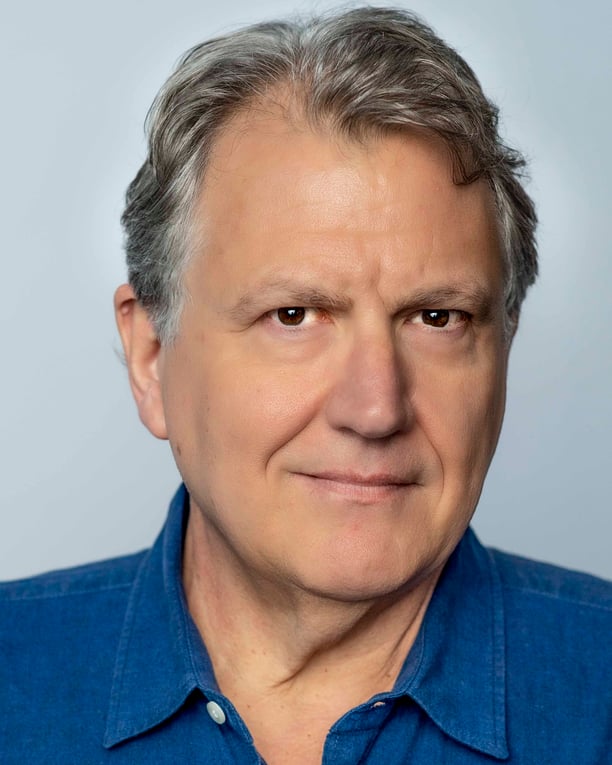 a man with a blue shirt and a tie