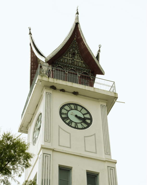 jam gadang, a clock tower with a clock on top of it