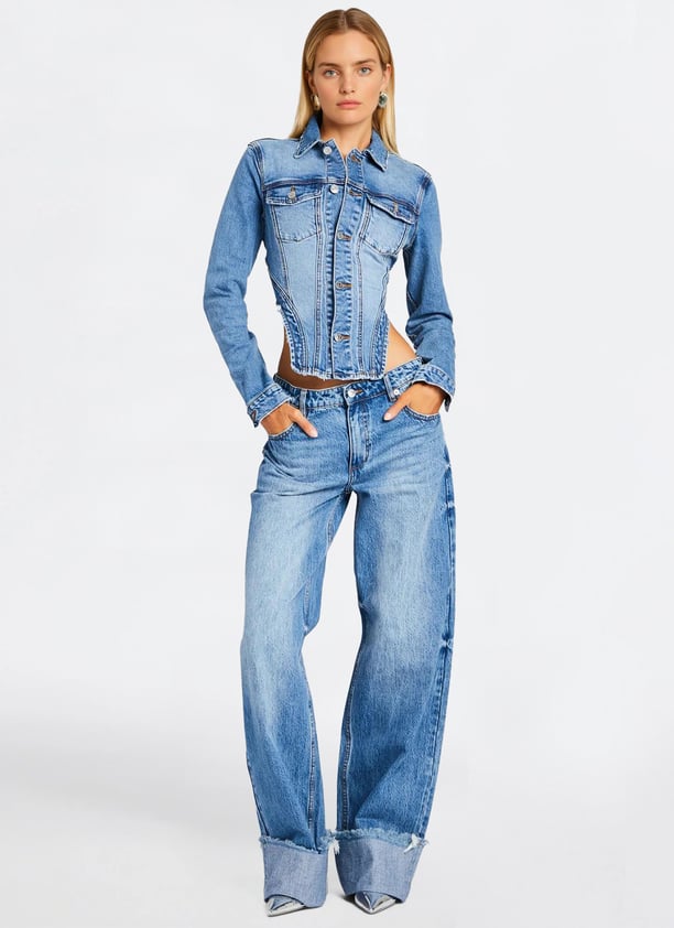 a woman in a denim jacket and jeans jeans
