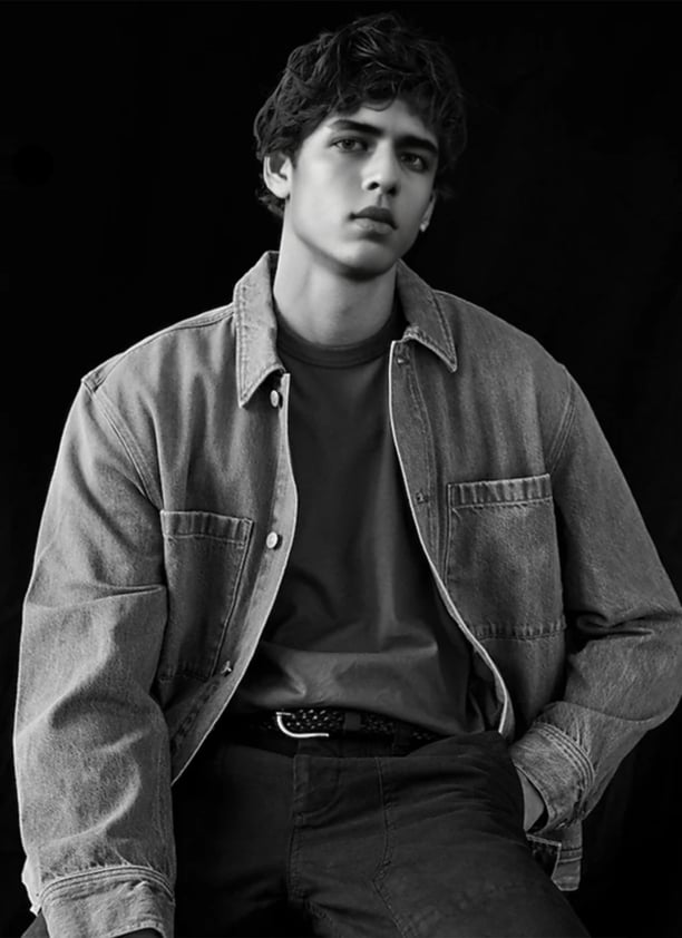 a man in a denim jacket and jeans