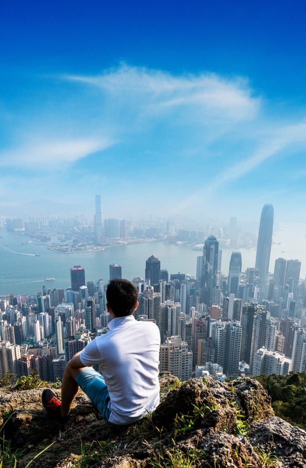 man-overlooking-hong-kong-skyline
