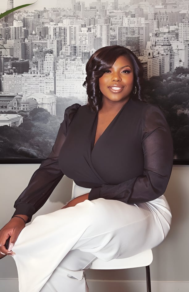 a woman in a black top and white pants