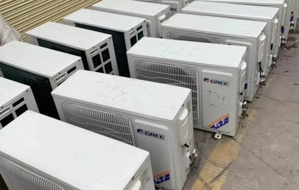 a bunch of air conditioners are lined up in a row