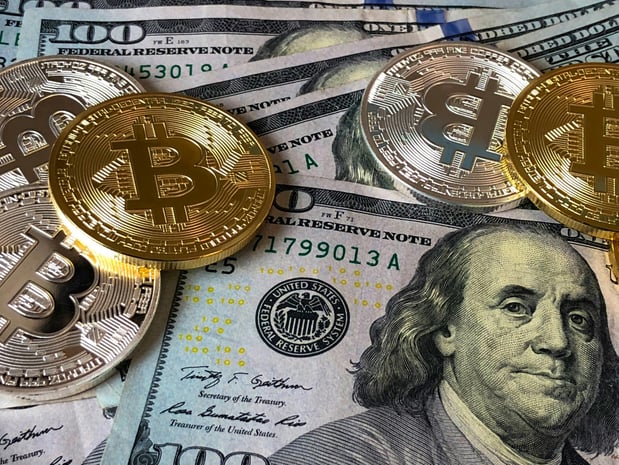 a pile of coins with a bitcoin on top of it