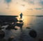 a man standing on rocks in the water