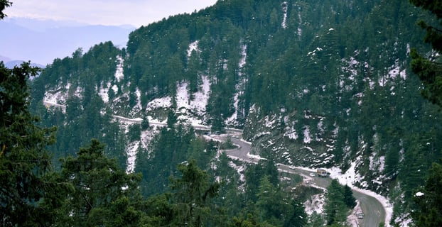 a mountain scene with a winding road and a winding road