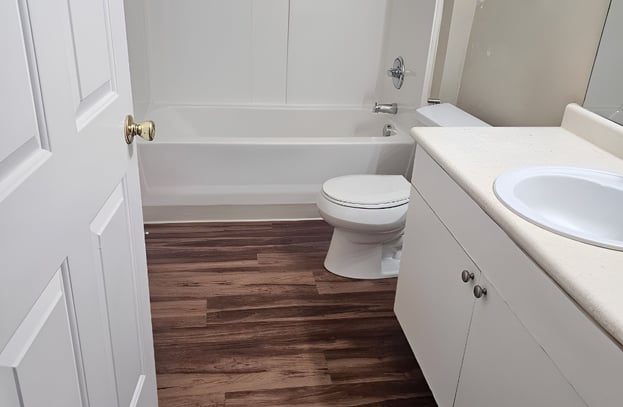 Clean bathroom beige cabinet and bathtub