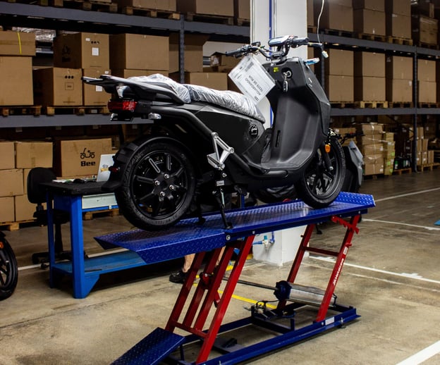 a motorcycle is parked in a garage with a lift