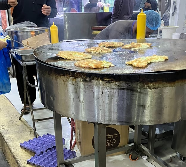 Street food eggs on a tawa