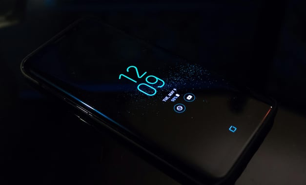 a cell phone with a glowing blue screen