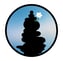 unanomalize podcast brand icon in a black circle with blue sky, black stacked stone cairn, white orchid growing out of cairn