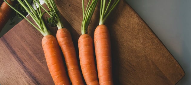 carrots and a knife on a wooden board