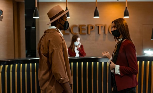 a man and woman in masks and masks on a reception table