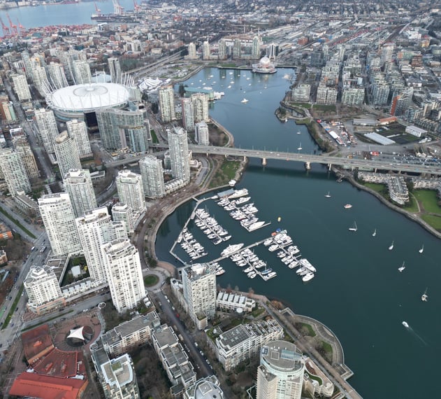 a cityscape of a city with a bridge and boats