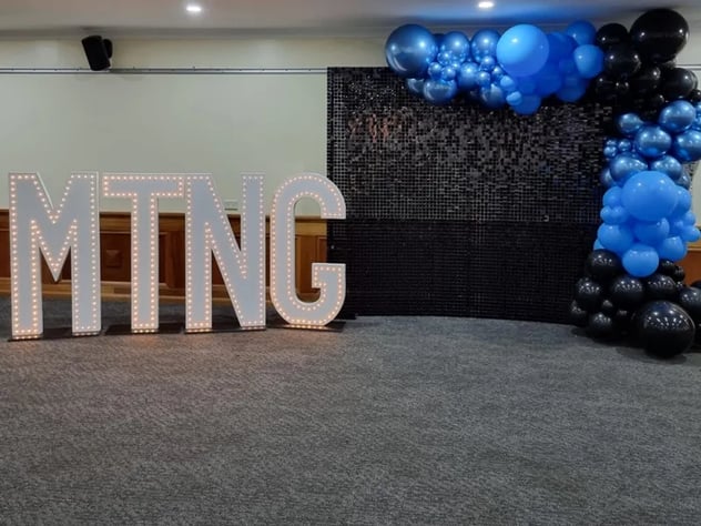 Black shimmer wall and garland for the MTNG cheer squad celebration in Springwood.