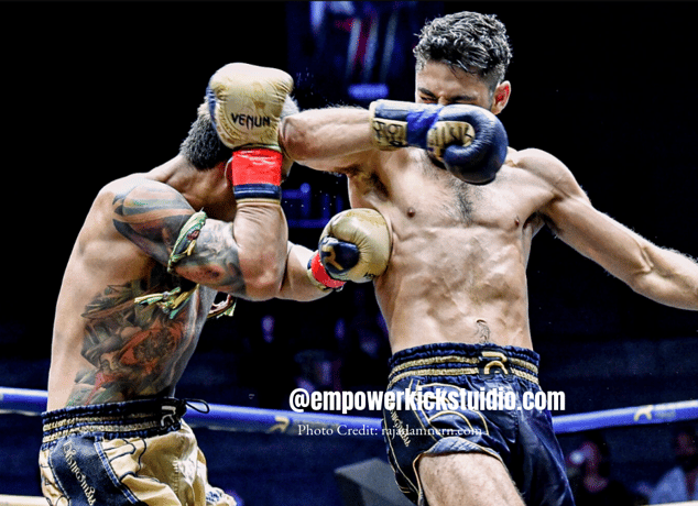a man in a boxing ring with a tattoo on his arm