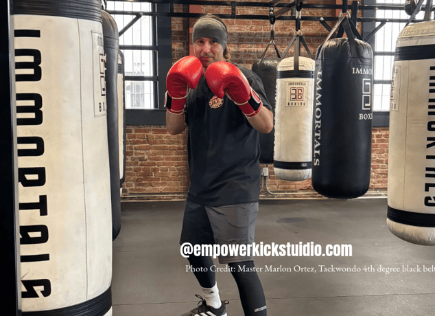 a man in a black shirt and red boxing gloves