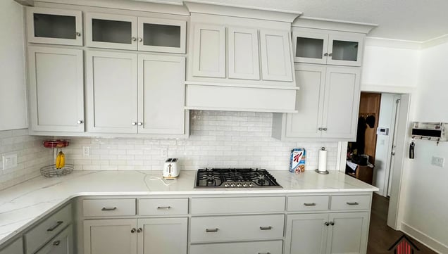 a kitchen with white cabinets and white cabinets