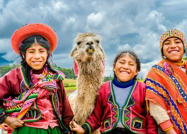 two happy kids from the Andes with a llama. Dos ninos felices de los Andes con una llama