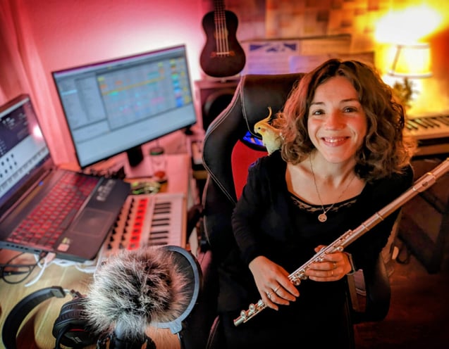 a woman in a recording studio with a microphone and a microphone