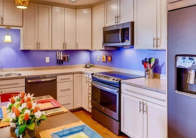 A kitchen with a table and a refrigerator