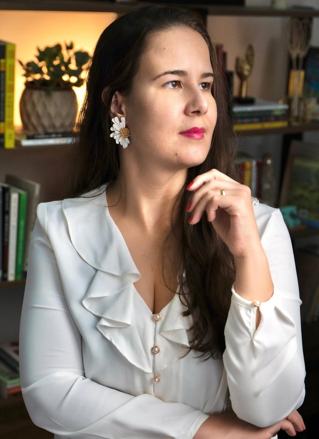 a woman in a white shirt and earrings