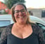 a woman with glasses and a black top apoderada en escuela de karate