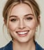 A close-up of a woman with blonde hair and a bright smile.