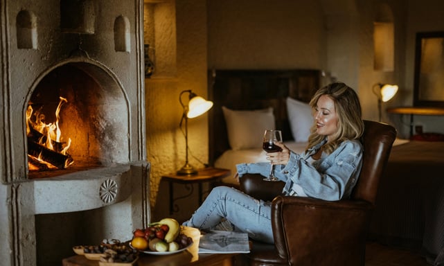 a woman sitting in a chair with a glass of wine