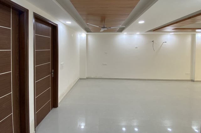 Spacious Living Room of 3 BHK Corner Builder Floor with Multiple Balconies — Chattarpur