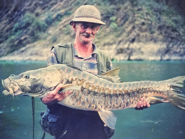 Legendary angler Christopher Oldmeadow holding a Golden Mahseer.