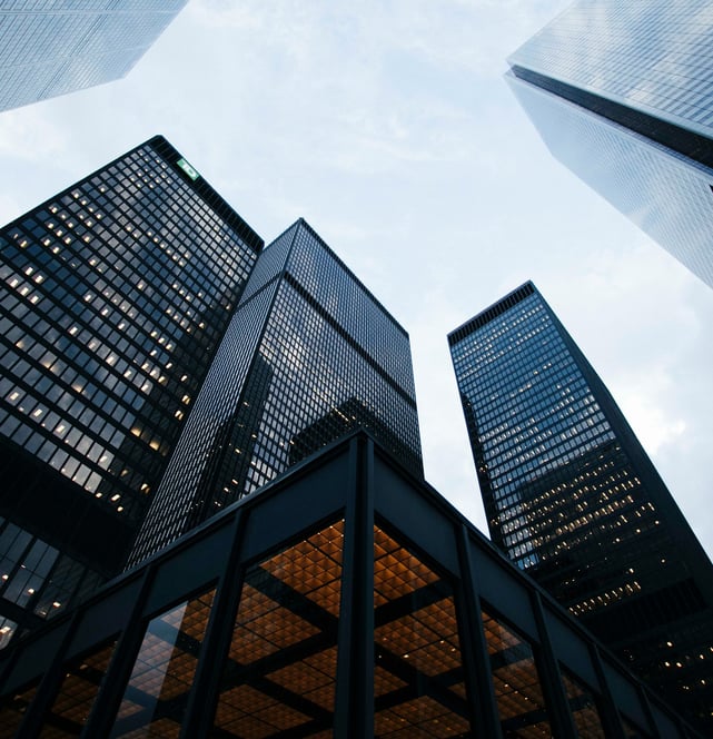 a group of tall buildings with a sky view of the city