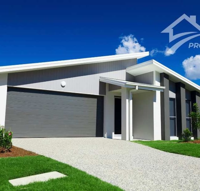 a house with a garage door and a driveway