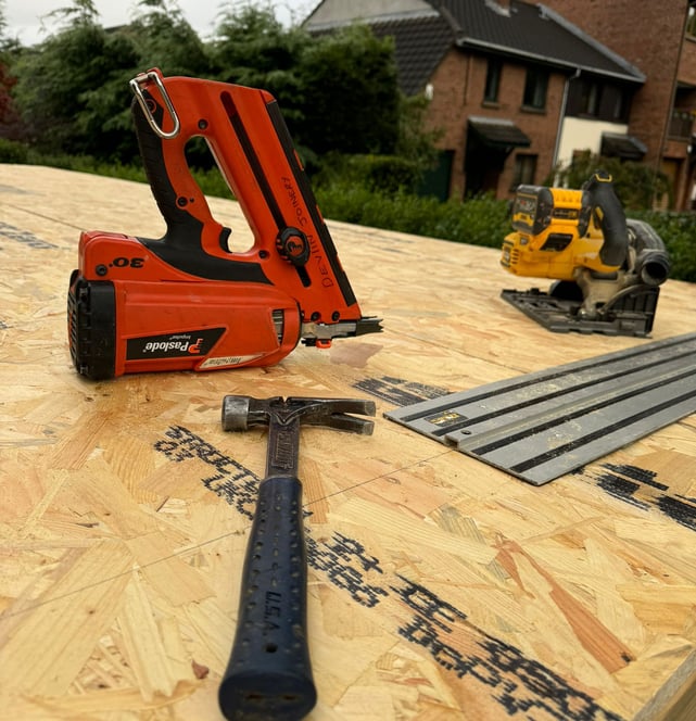 Image showing nail gun and hammer on top of garage roof being renovated