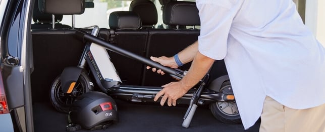 a man in a white shirt is holding a bike racket