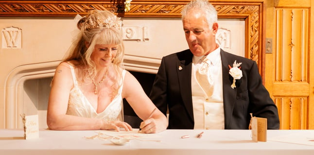 Couple Signing Certificate At Their Tying The Knot Ceremony