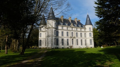 Château de Coat-an-Noz with its elegant turrets and slate roof, a historic castle nestled in the Bre